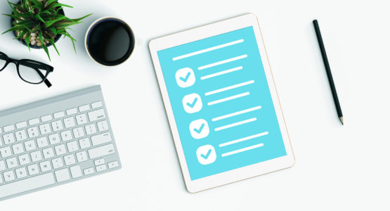 Checklist app on a tablet sitting on a desk