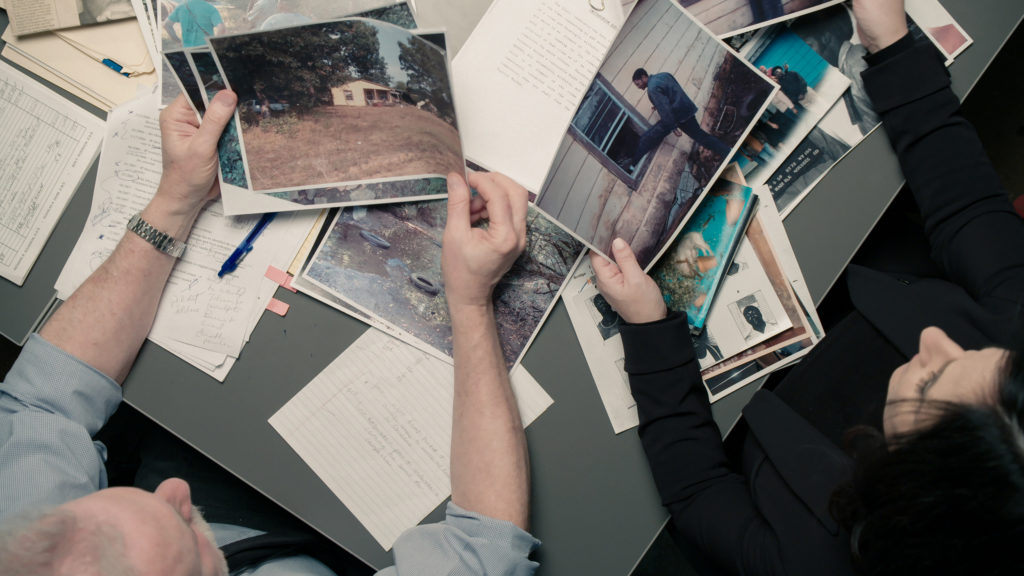 Detectives sorting through crime photos